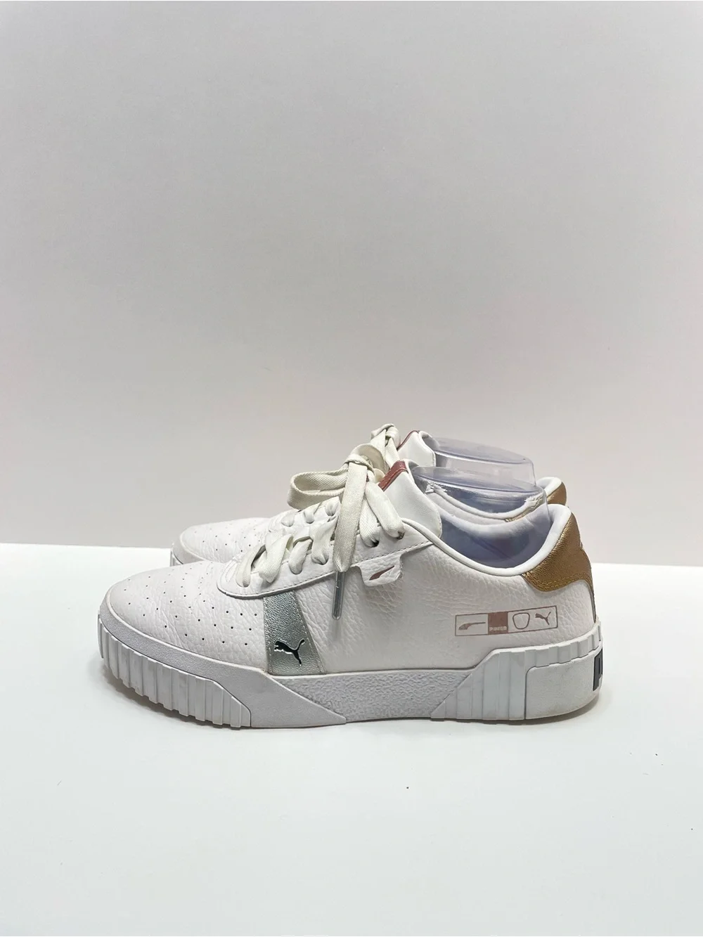 Women’s 7.5 Puma Cali Hacked White with gold and silver accents